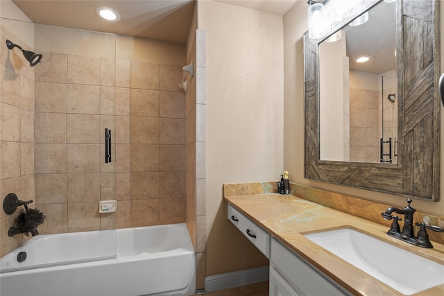 bathroom with tiled shower / bath and vanity