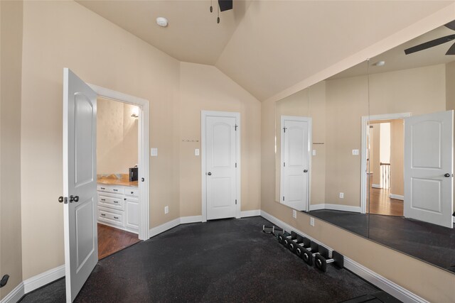 exercise area featuring vaulted ceiling and ceiling fan