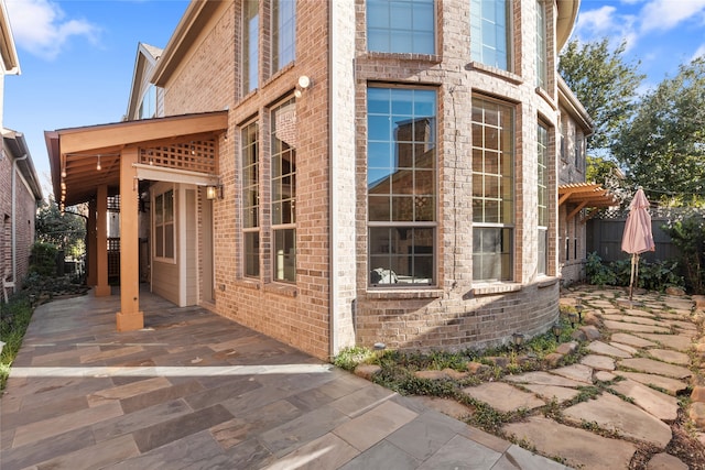 view of property exterior with a patio