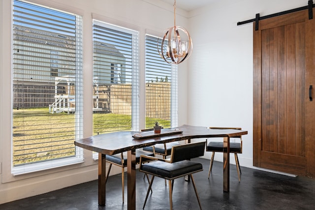 dining area featuring ornamental molding and a barn door