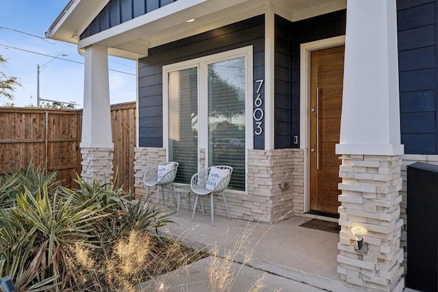 view of exterior entry with a porch