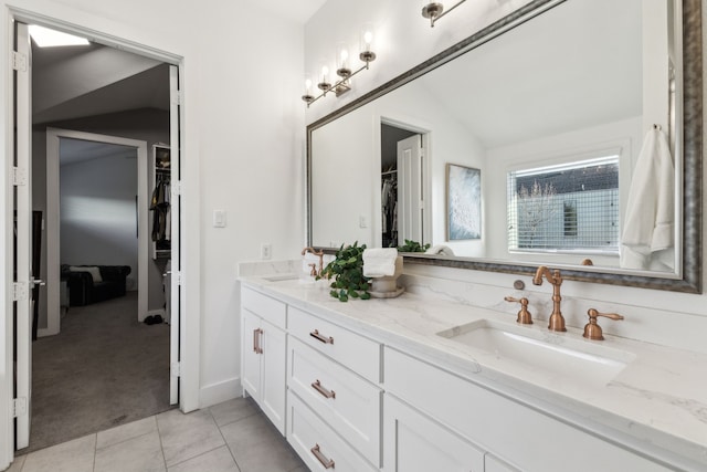 bathroom with vanity, tile patterned floors, and lofted ceiling