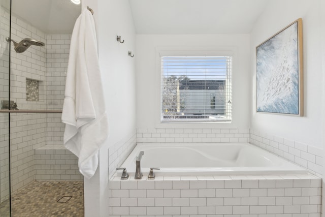 bathroom featuring vaulted ceiling and shower with separate bathtub