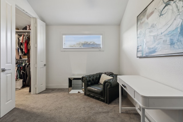 living area featuring lofted ceiling and carpet