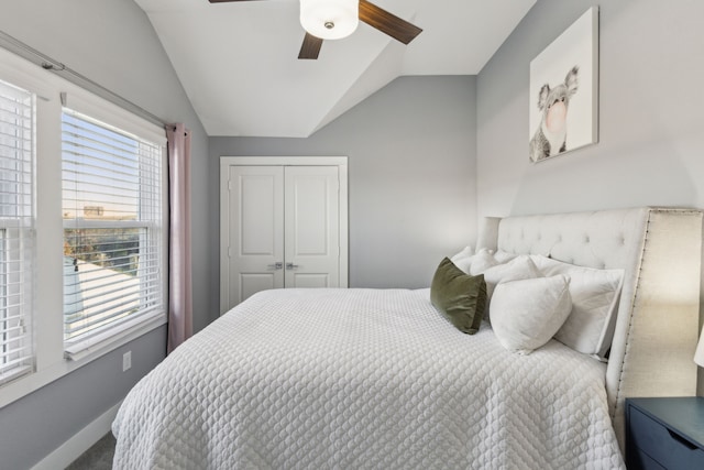 bedroom featuring ceiling fan, lofted ceiling, and a closet