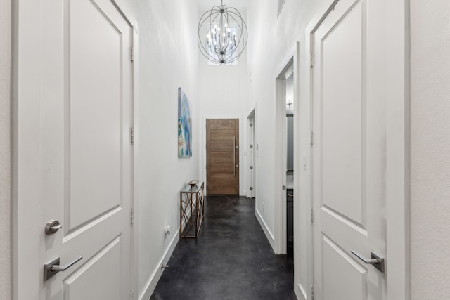 hall featuring a high ceiling and a chandelier