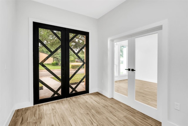 foyer featuring french doors and light hardwood / wood-style flooring