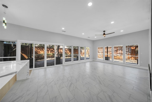 unfurnished living room with ceiling fan