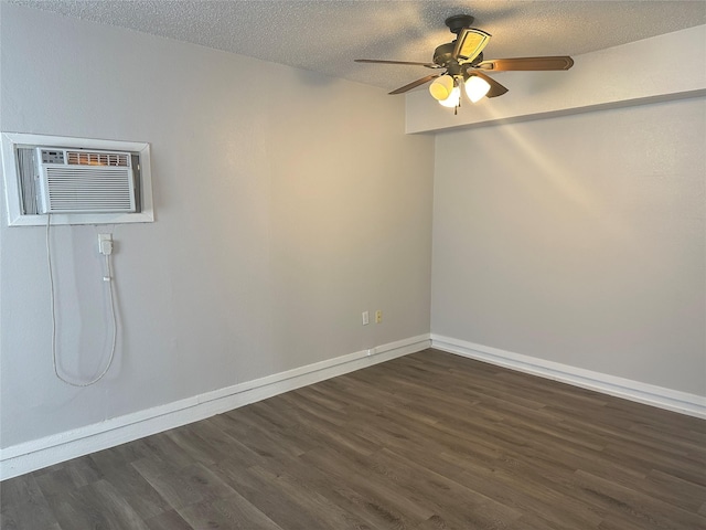 unfurnished room featuring ceiling fan, dark wood-type flooring, a textured ceiling, and a wall unit AC