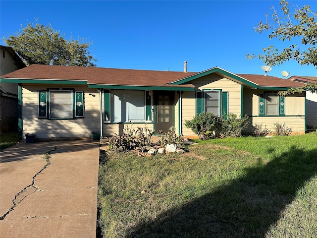 ranch-style home featuring a front yard