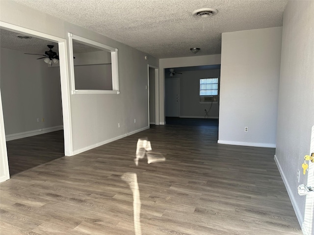 empty room featuring hardwood / wood-style floors, a textured ceiling, and ceiling fan