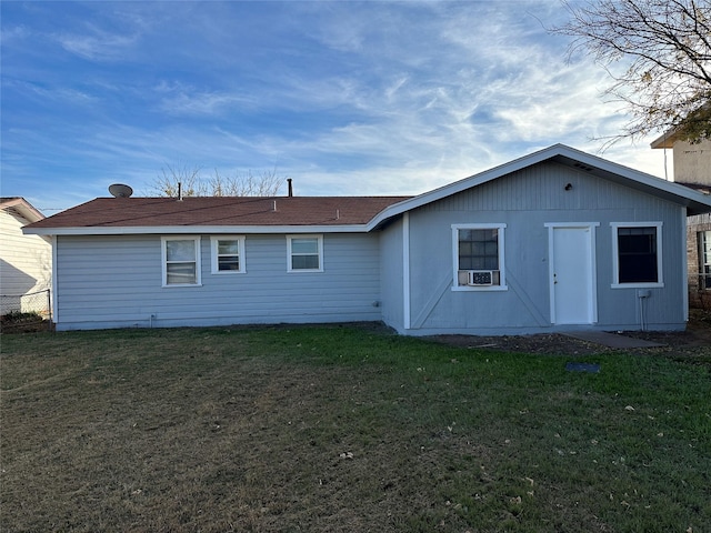 rear view of property with cooling unit and a yard