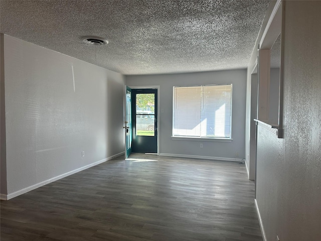 spare room featuring dark wood-type flooring