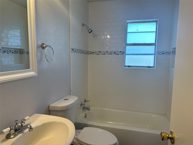 full bathroom with sink, toilet, and tiled shower / bath combo