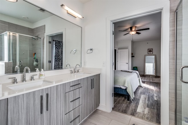 bathroom featuring ceiling fan, walk in shower, and vanity