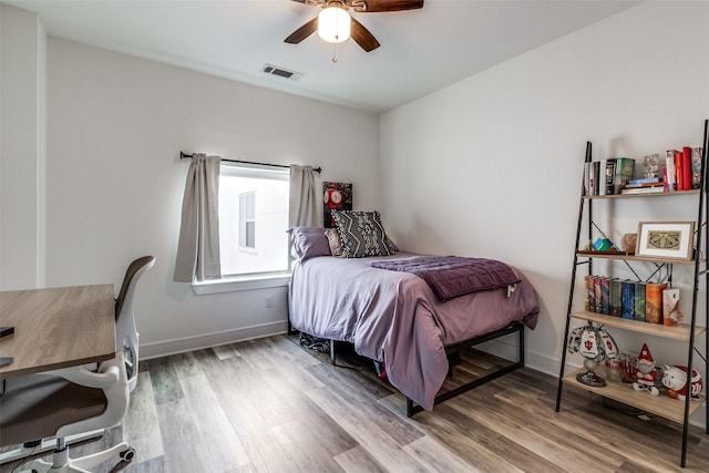 bedroom with wood-type flooring and ceiling fan