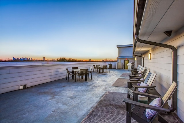 patio terrace at dusk featuring grilling area