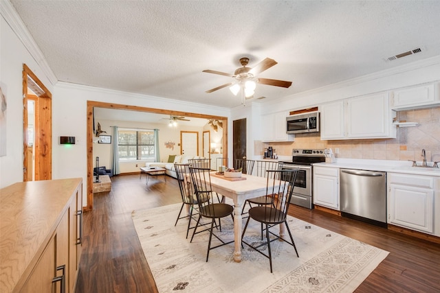 living room with ceiling fan, dark wood-type flooring, a textured ceiling, and lofted ceiling