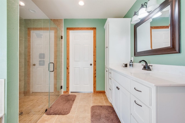 laundry area featuring washing machine and dryer, hardwood / wood-style flooring, cabinets, and water heater