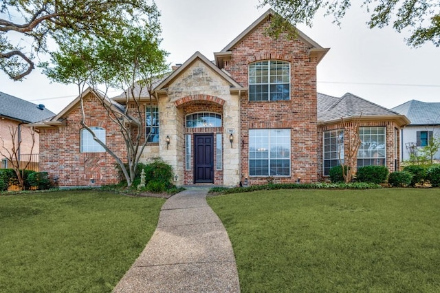 view of front of property featuring brick siding and a front lawn