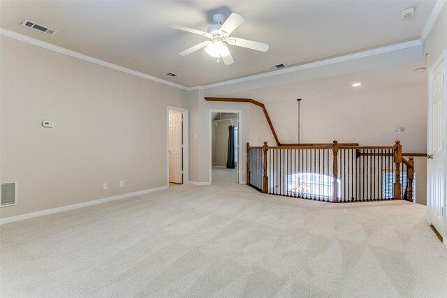 unfurnished bedroom with ceiling fan, ornamental molding, light carpet, and ensuite bath