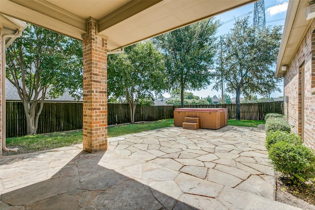 view of patio featuring a fenced backyard and a hot tub