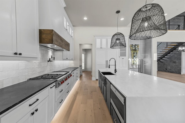 kitchen with white cabinetry, pendant lighting, and appliances with stainless steel finishes