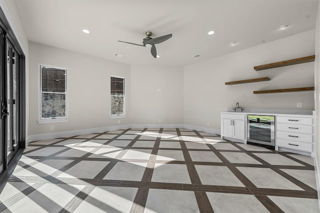 bar featuring ceiling fan, white cabinetry, and beverage cooler