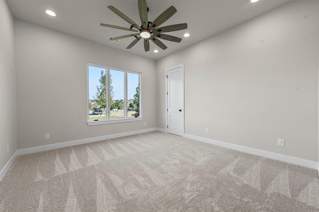 carpeted spare room with ceiling fan