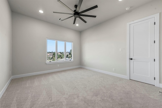 carpeted spare room with ceiling fan