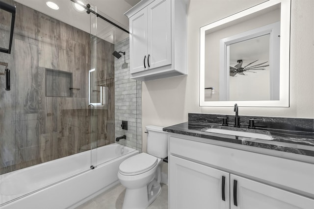 full bathroom with tile patterned flooring, ceiling fan, toilet, shower / bath combination with glass door, and vanity