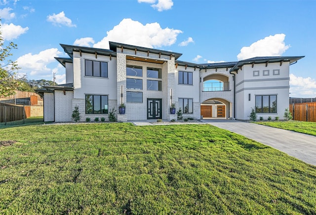 view of front facade with a front yard and french doors