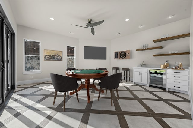 interior space featuring ceiling fan, bar area, and beverage cooler