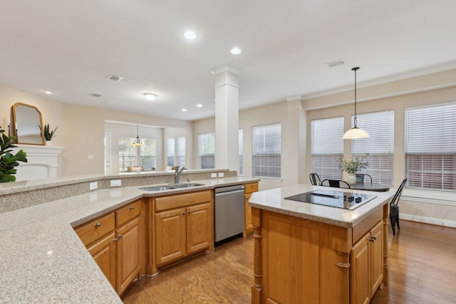 kitchen with sink, dishwasher, black electric stovetop, and light stone counters