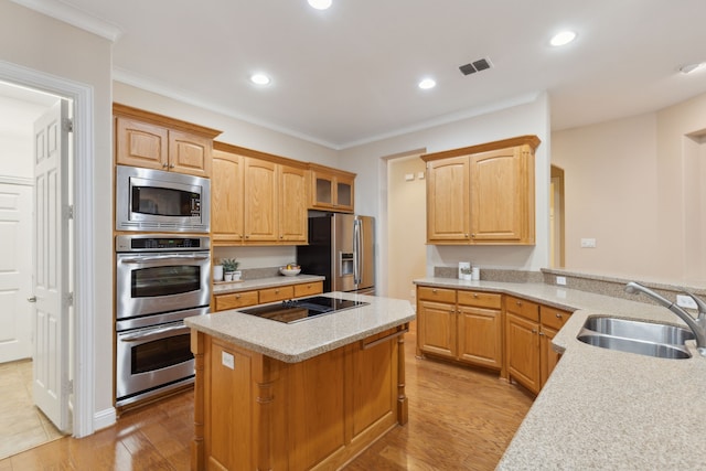 kitchen featuring sink, crown molding, kitchen peninsula, and stainless steel appliances