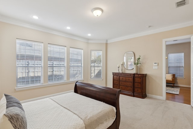 carpeted bedroom featuring crown molding