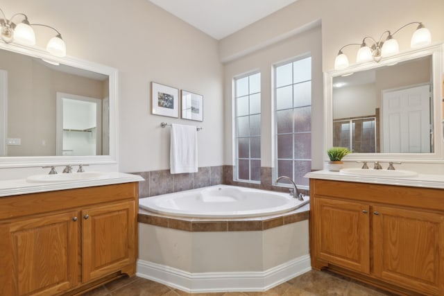 bathroom featuring vanity and tiled tub