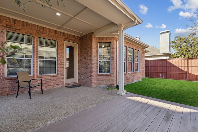 wooden deck featuring a lawn