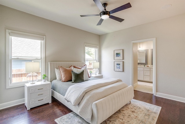 bedroom with ceiling fan, dark hardwood / wood-style flooring, and ensuite bath