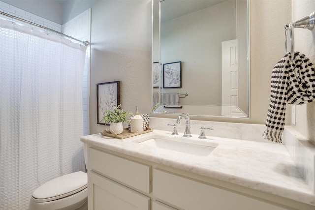 bathroom with toilet and vanity