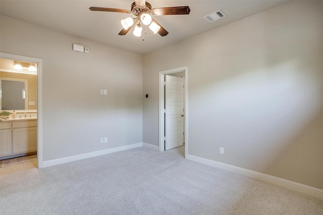 interior space featuring sink, ceiling fan, and light carpet