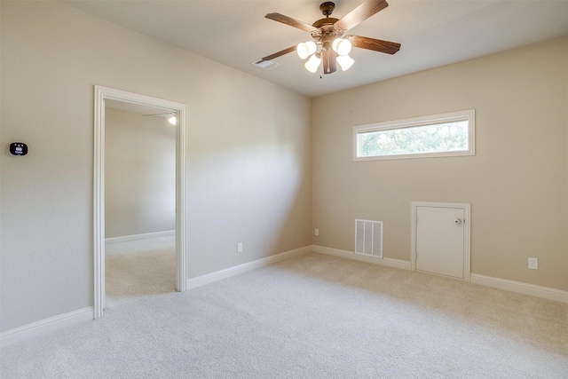 carpeted spare room with ceiling fan