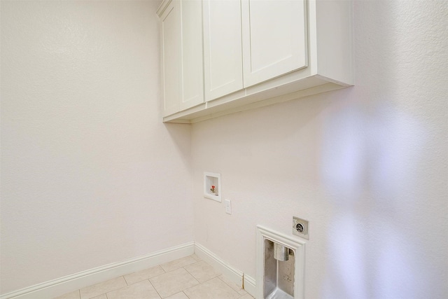 clothes washing area featuring electric dryer hookup, cabinets, hookup for a washing machine, and light tile patterned flooring