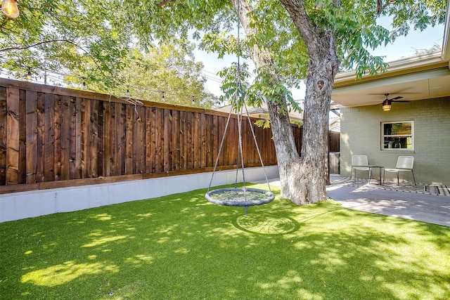 view of yard featuring a patio area and ceiling fan