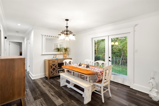 dining area with an inviting chandelier, ornamental molding, and dark hardwood / wood-style flooring