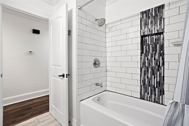 bathroom featuring ornamental molding, hardwood / wood-style flooring, and shower / tub combo