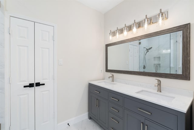 bathroom featuring a shower with door and vanity