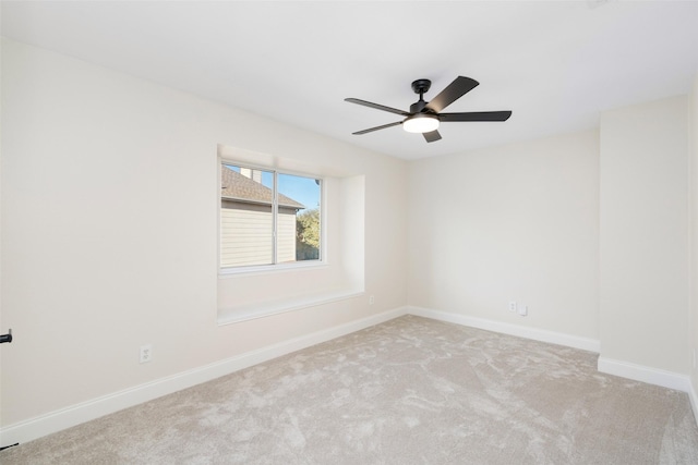 empty room featuring light carpet and ceiling fan