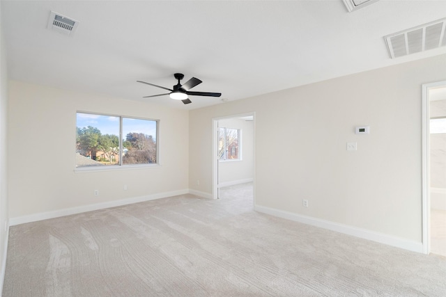 carpeted spare room with ceiling fan