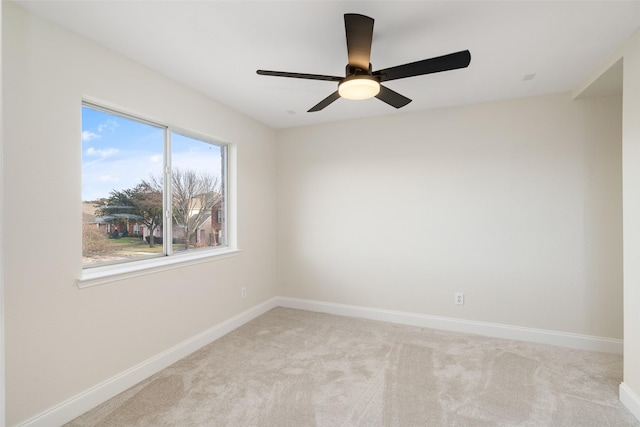 spare room featuring ceiling fan and light carpet